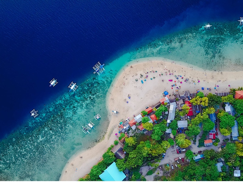 Boracay'da turkuaz denizin ve sahildeki evlerin kuş bakışı renkli görüntüsü
