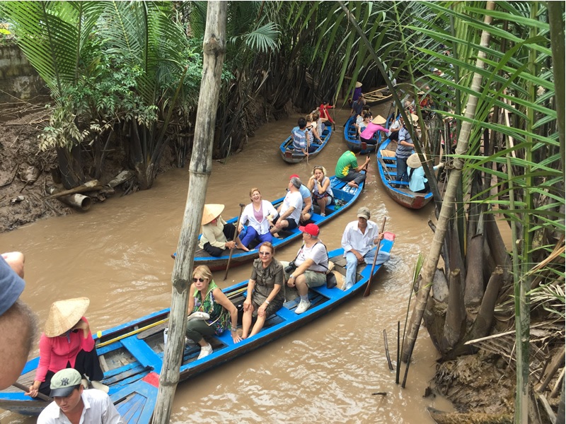 Vietnam mekong deltasında sal ile gezen turistler